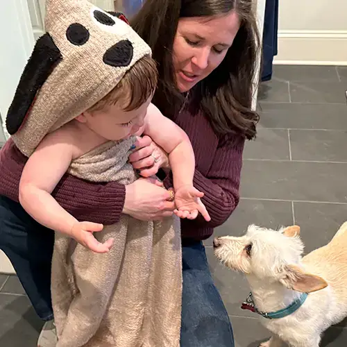 child in a Dog hooded towel with mom and dog