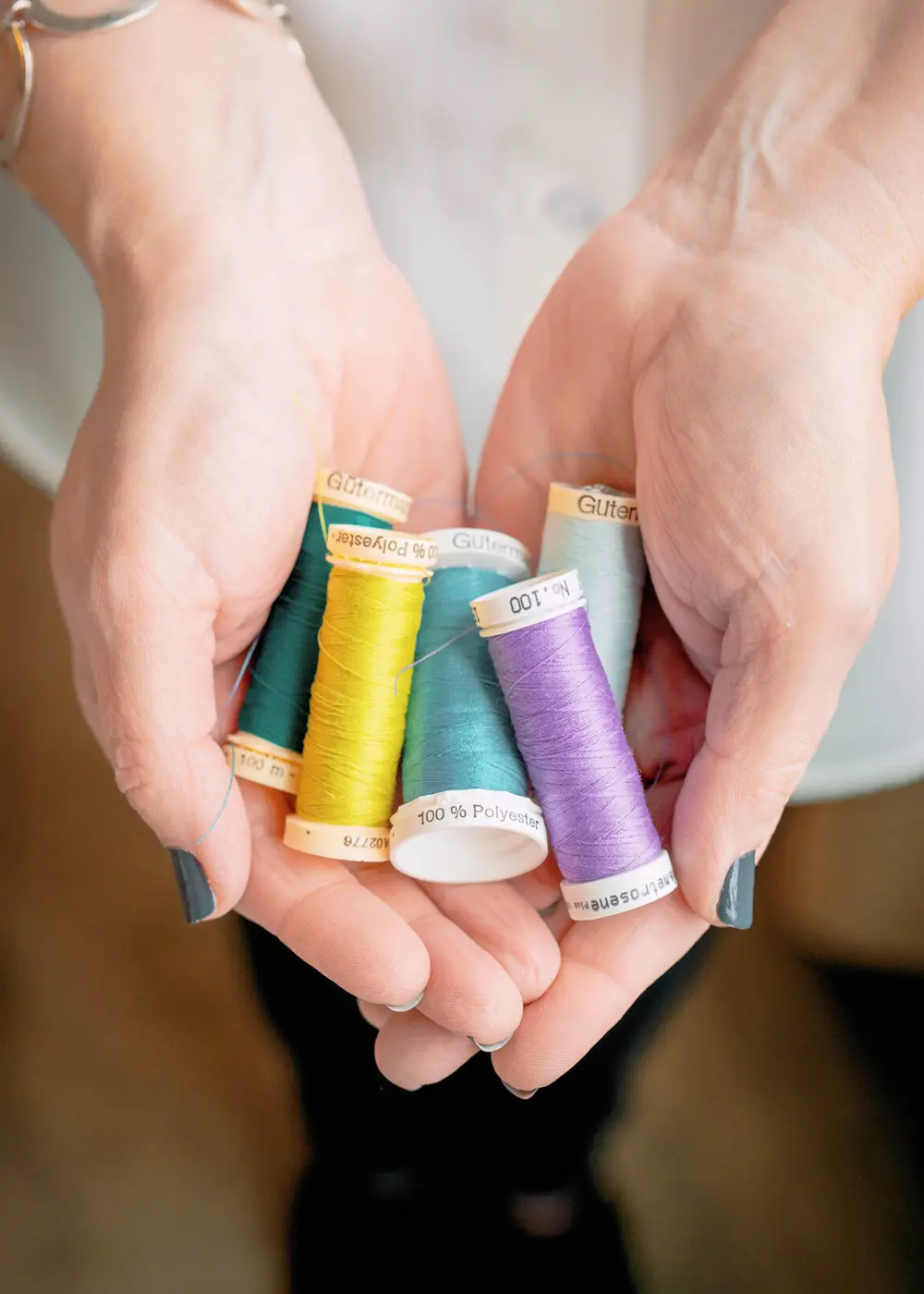 woman holding thread in hands