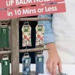 Handmade fabric lip balm holders displayed on a wooden rack at a craft market with text saying they can be made in 10 minutes or less.