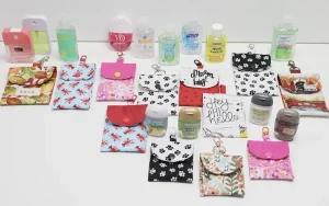 Fabric hand sanitizer holder sewing pattern in five sizes designed to fit most popular travel hand sanitizer bottles with beginner-friendly PDF instructions.