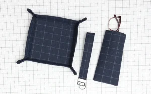 Sewing Projects Made From Men’s Shorts: Coordinating dark plaid fabric tray, key wristlet and eyeglasses case sewn from repurposed men’s shorts.